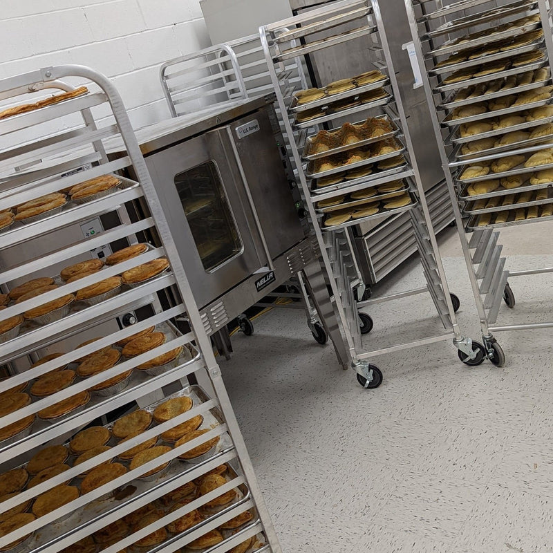 Trays of pies and pastries on racks in the Halifax bakery
