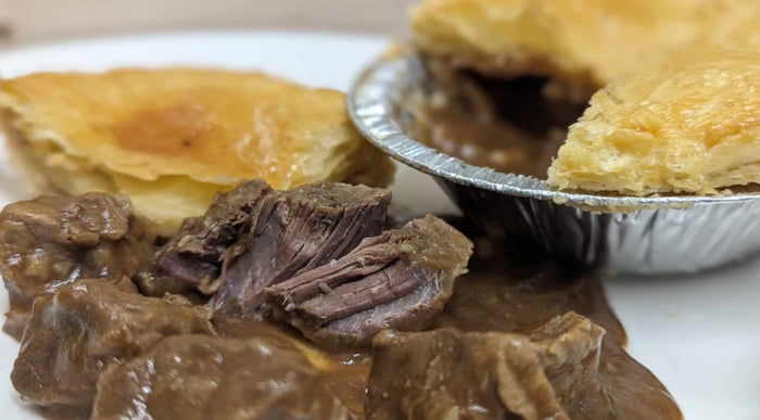 Steak pie cut open to show its beef filling and pastry