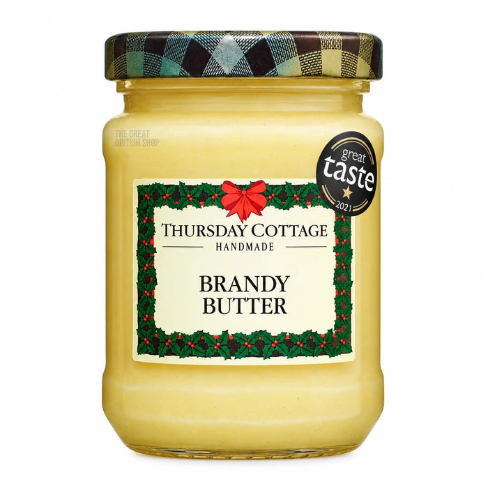 Thursday Cottage Brandy Butter 110g jar, with a tartan lid, holly-bordered label and Great Taste award sticker.